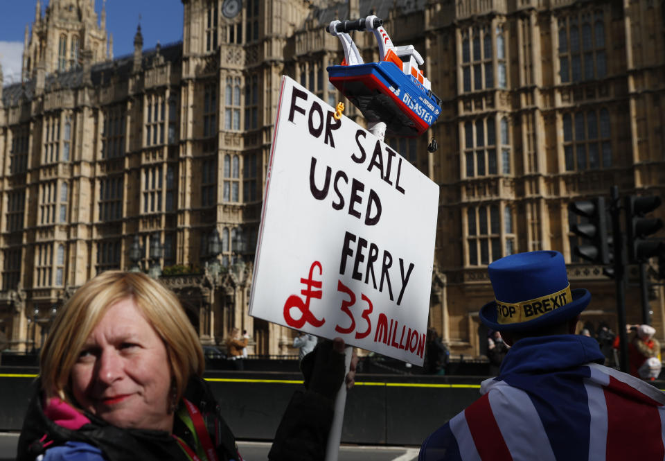 Pro-remain protester Steve Bray, right, continues his demonstration with fellow anti Brexit protesters in London, Monday, March 11, 2019. British Prime Minister Theresa May still hopes to secure changes from the EU that can win U.K. lawmakers' backing for her Brexit deal, despite a lack of progress in last-minute talks. (AP Photo/Alastair Grant)