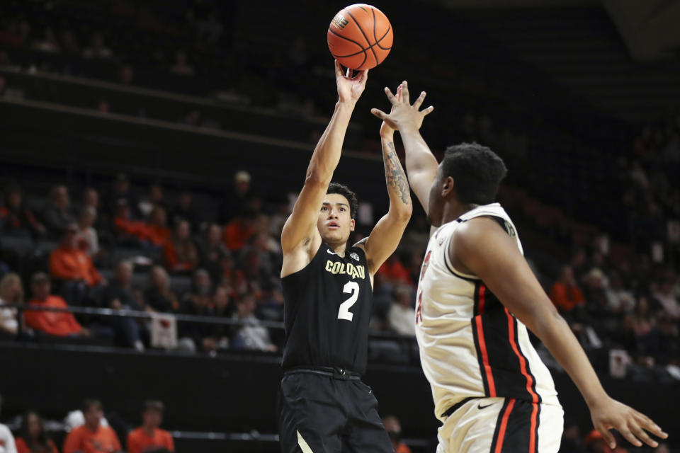 Colorado guard KJ Simpson (2) shoots over Oregon State center KC Ibekwe, right, during the second half of an NCAA college basketball game Saturday, March 9, 2024, in Corvallis, Ore. (AP Photo/Amanda Loman)