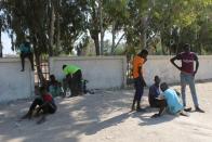 Migrants are seen on the street, after being rescued by Libyan coast guard, in Misrata