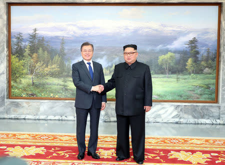 South Korean President Moon Jae-in shakes hands with North Korean leader Kim Jong Un during their summit at the truce village of Panmunjom, North Korea, in this handout picture provided by the Presidential Blue House on May 26, 2018. The Presidential Blue House /Handout via REUTERS