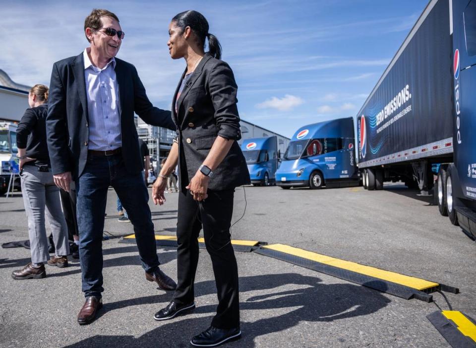 Kirk Tanner, CEO of PepsiCo Beverages North America, talks with PBNA vice president Erica Edwards after they introduced 18 new Tesla Semi electric trucks at their Sacramento facility on Tuesday.