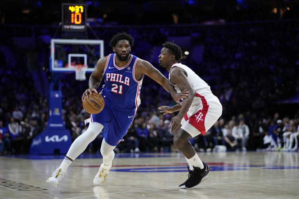 Philadelphia 76ers' Joel Embiid, left, tries to get past Houston Rockets' Jae'Sean Tate during the first half of an NBA basketball game, Monday, Jan. 15, 2024, in Philadelphia. (AP Photo/Matt Slocum)