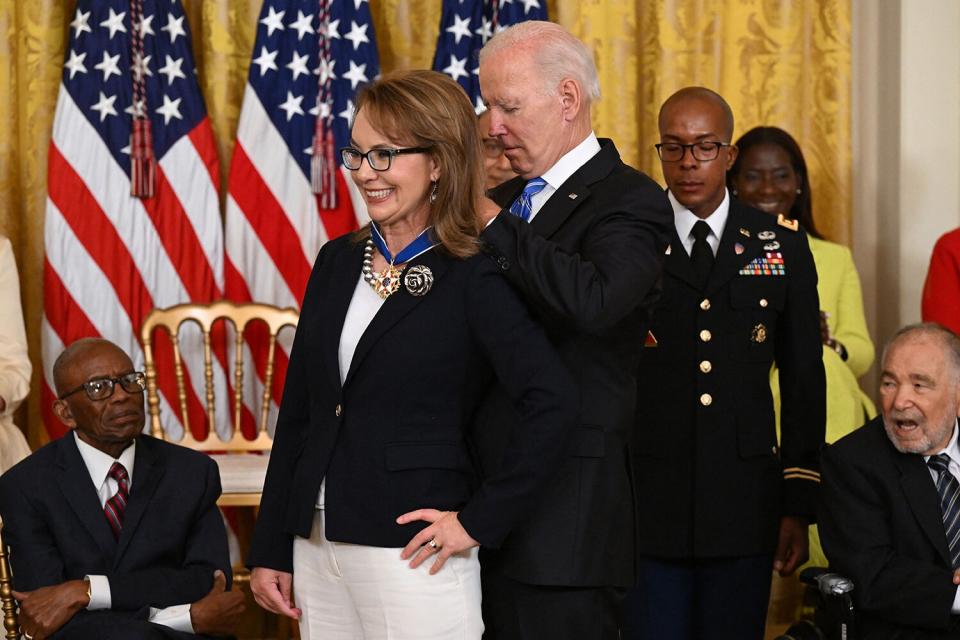 US President Joe Biden presents former Congresswoman Gabby Giffords with the Presidential Medal of Freedom, the nation's highest civilian honor, during a ceremony honoring 17 recipients, in the East Room of the White House in Washington, DC, July 7, 2022.