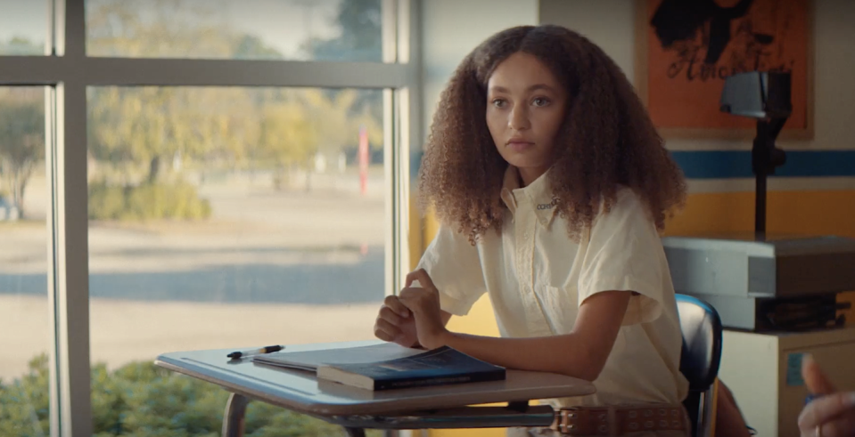 nico parker in suncoast, a young woman sits at a desk in a classroom