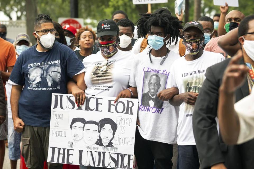 On 16 May, Ahmaud Arbery’s aunt Theawanza Brooks, center left, joins other family members and supporters in a march from the Glynn county courthouse to a police station.