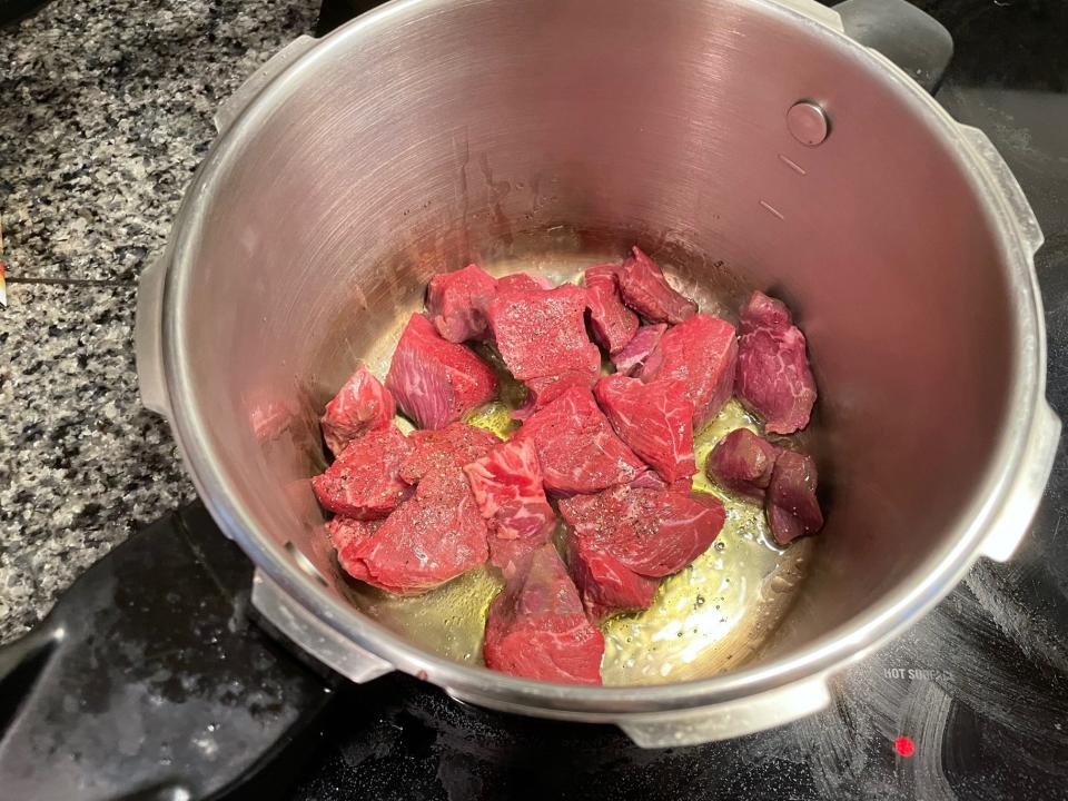 Meat cooking in pot for Greek dad's kritharaki