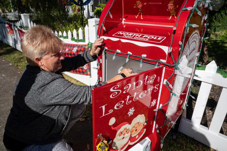 Linda Bokland checks the mailbox for their “Letters to Santa” project at their home in Mount Dora.