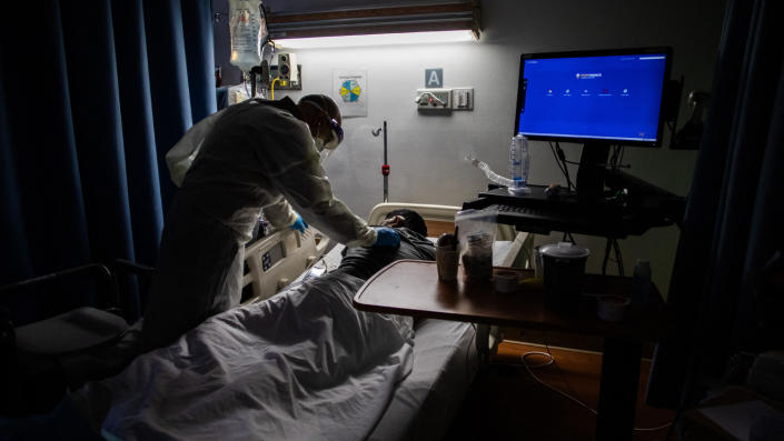Delkhah Shahin, a doctor, checks on a 34-year-old, unvaccinated, COVID-19 patient at Providence Cedars-Sinai Tarzana Medical Center in Tarzana, Calif., in September.