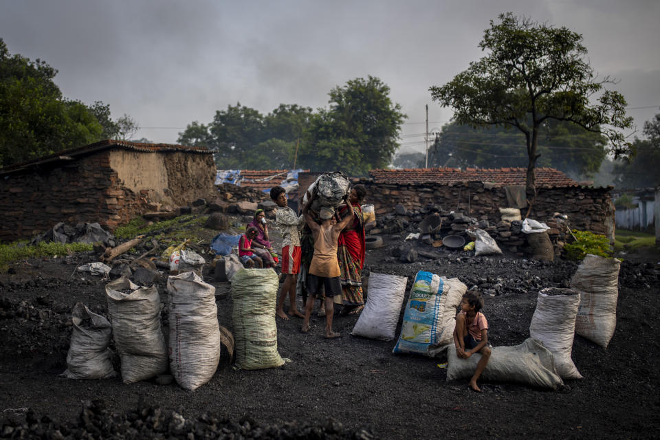 Sacks filled with scavenged coal is ready to be transported and sold to traders in Dhanbad, an eastern Indian city in Jharkhand state, Friday, Sept. 24, 2021. No country will see energy needs grow faster in coming decades than India, and even under the most optimistic projections part of that demand will have to be met with dirty coal power — a key source of heat-trapping carbon emissions. (AP Photo/Altaf Qadri)