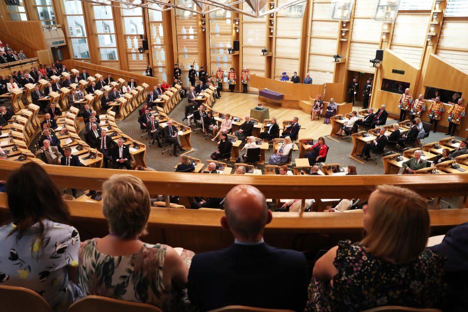 Queen Elizabeth II, the Duke of Rothesay and MSPs listen to performers during a ceremony marking the 20th anniversary of devolution in the Holyrood chamber at the Scottish Parliament in Edinburgh, Scotland.