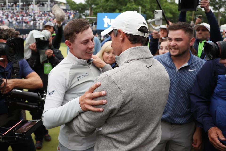 Matt Fitzpatrick is embraced by Rory McIlroy on the 18th green (Getty Images)