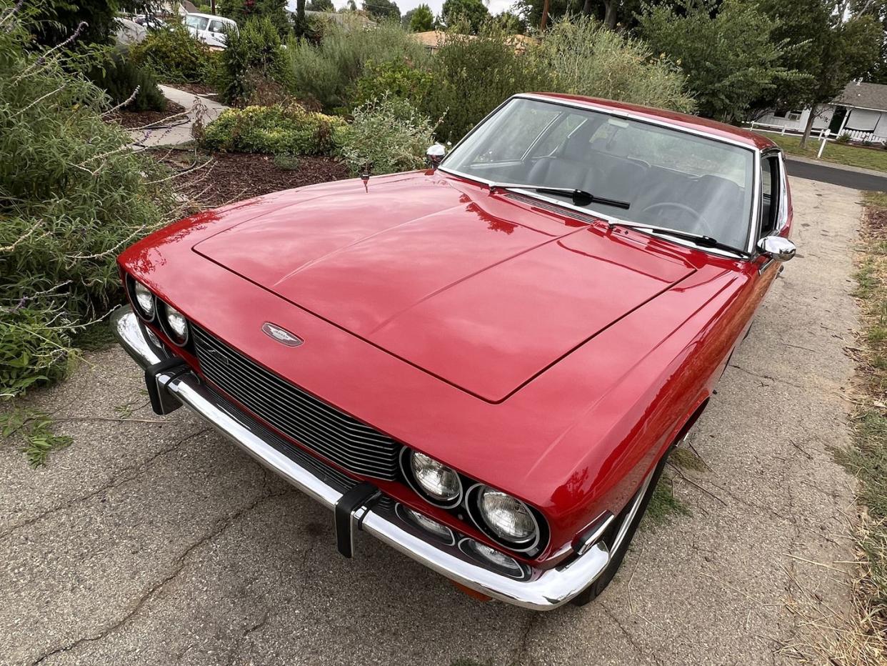 a red car parked on a driveway