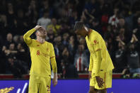 Liverpool's Andrew Robertson, left, and Liverpool's Joel Matip react after the English Premier League soccer match between Brentford and Liverpool at the Brentford Community Stadium in London, Saturday, Sept. 25, 2021. (AP Photo/Rui Vieira)