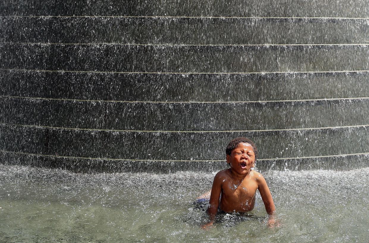 Three-year-old Jordan Pebels, of Port Orchard, cools off in falling water at Harborside Fountain Park in downtown Bremerton on Monday, June 27, 2022.