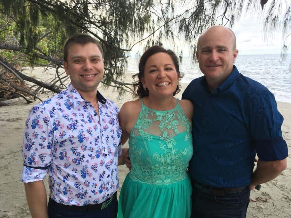 Teresa Leggett with her ex husband and his new husband on a beach