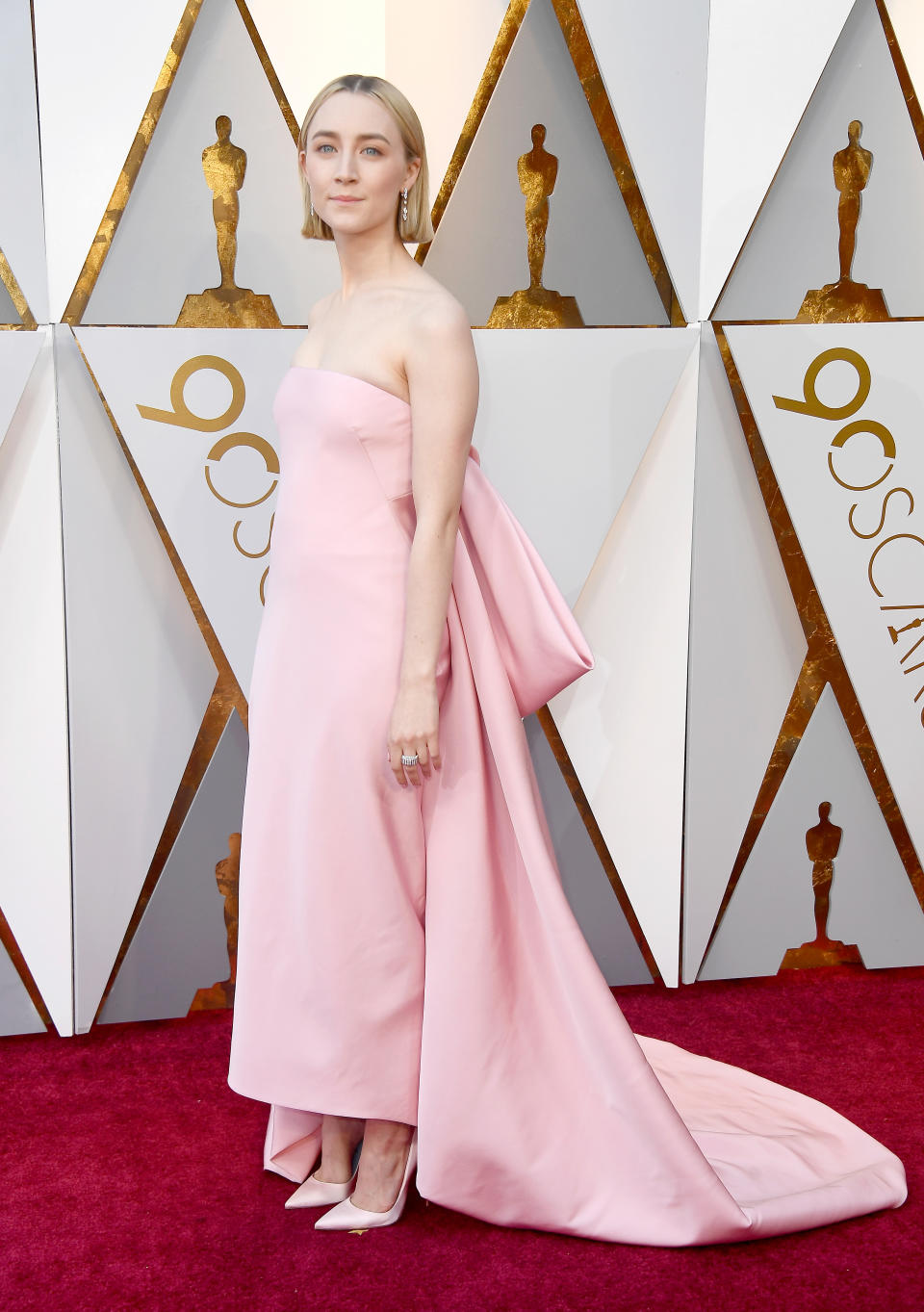 <p>Saoirse looked pretty in pink in 2018 in her strapless Calvin Klein by Appointment dress. The brainchild of Raf Simons, was jazzed up with a large bow on the back and sat perfectly with the actress’ newly cropped hairdo. </p>