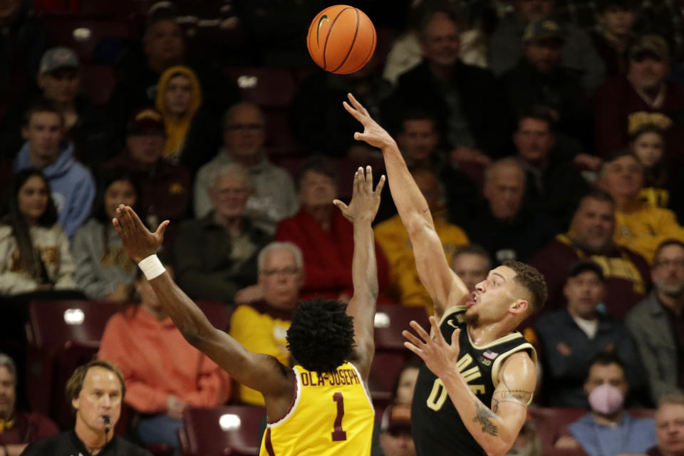 Purdue forward Mason Gillis (0) shoots over Minnesota forward Joshua Ola-Joseph (1) in the first half of an NCAA college basketball game, Thursday, Jan. 19, 2023, in Minneapolis. (AP Photo/Andy Clayton-King)