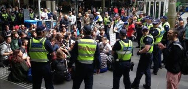 Student protesters stage a sit-in at the intersection of Bourke and Swanston Streets. Photo: 7News