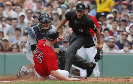 Jul 16, 2017; Boston, MA, USA; Boston Red Sox first baseman Sam Travis (59) tagged out at home plate by New York Yankees catcher Austin Romine (27) in the second inning at Fenway Park. Mandatory Credit: David Butler II-USA TODAY Sports
