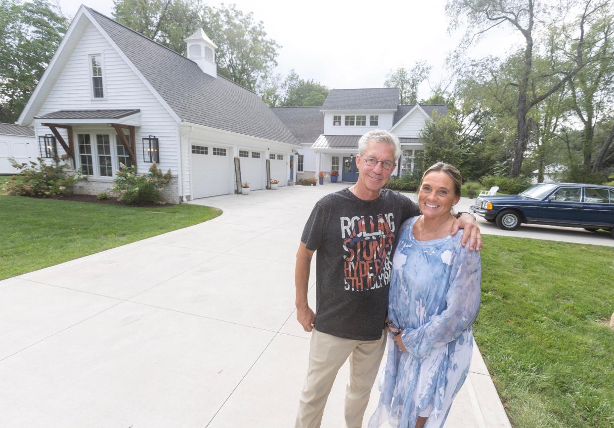 Michael Kell and Sally Goodnow stand in the driveway of the modern farmhouse they share in Plain Township. The house, built in 2019, has many of the elements of the style popularized by HGTV stars Chip and Joanna Gaines: metal roofing accents, rough-sawn wood timbers and a palette dominated by white, gray and black.