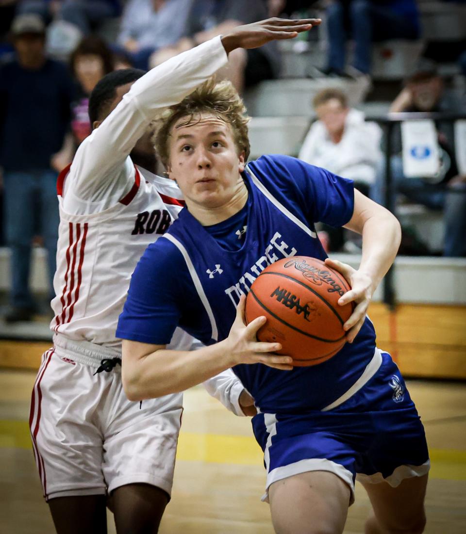 Dundee's Ethan Layton, drives to the basket against Eshone Chiles of Dearborn Heights Robichaud during Dundee's 47-45 victory in the semifinals of the Division 2 Regional at Flat Rock on Tuesday, March 5, 2024.