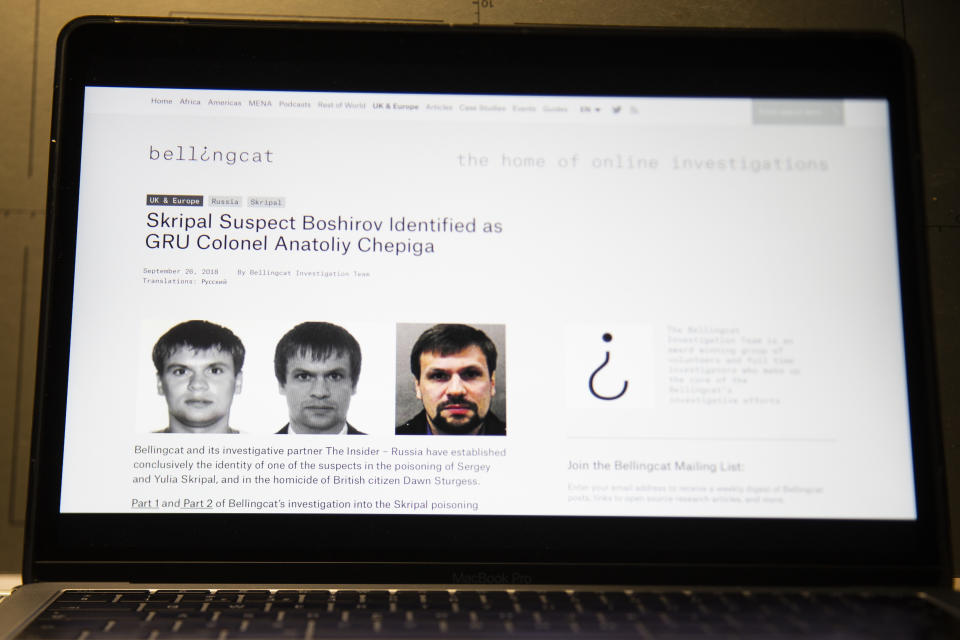 FILE - This Thursday, Sept. 27, 2018 file photo shows the website for British investigative group Bellingcat with one of the two suspects in the March poisoning of Sergei Skripal and his daughter in England. After seeing its secrets increasingly exposed by determined journalists and Kremlin critics, the Russian military intelligence agency known as the GRU endured another hit Friday, Oct. 26: A new report details misbehavior, sloppiness and bizarre bureaucratic decisions that allowed a Russian journalist to identify multiple alleged GRU officers. While no one is suspected of grave wrongdoing, journalist Sergei Kanev says he wants to call attention to problems within an organization that he feels has crossed a line beyond traditional spying into unchecked violence and foreign interference. (AP Photo/Alexander Zemlianichenko, file)