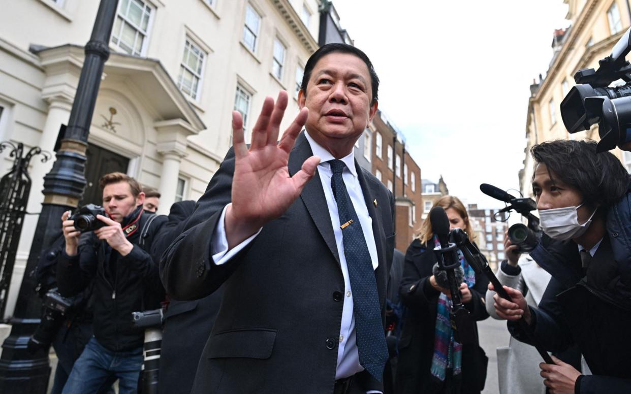 Myanmar's Ambassador to the United Kingdom, Kyaw Zwar Minn, is surrounded by members of the media on his arrival at the Myanmar Embassy in London - AFP