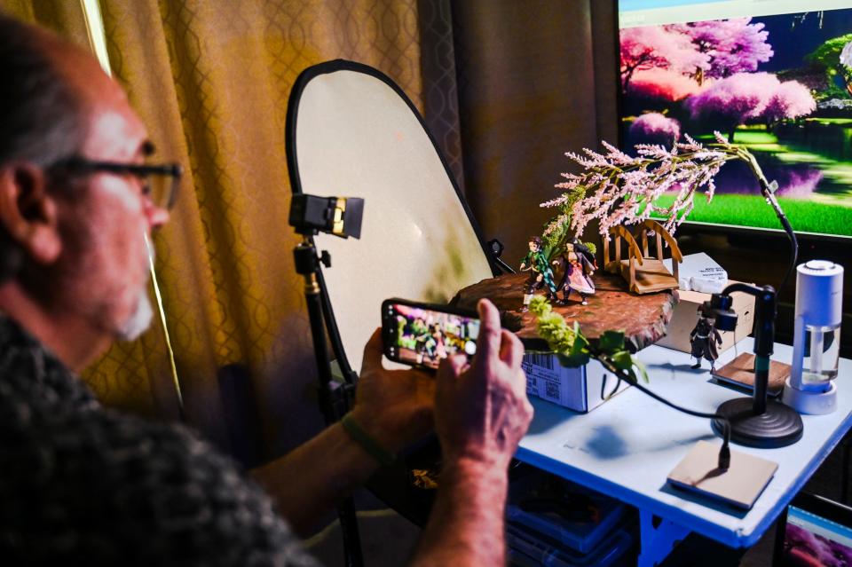 Kevin Epling takes photographs of one of his toy photography art sets on Wednesday, May 24, 2023, at his home in East Lansing.