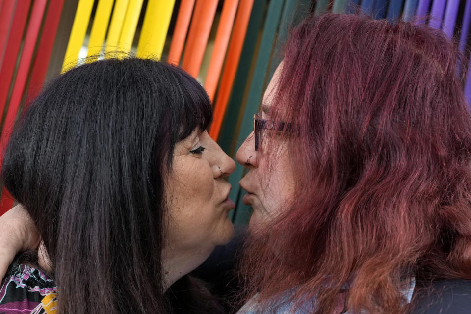 Avril Clark, left, and Lucy pose for a photograph during an interview at their house in London, Tuesday, June 11, 2024. Avril Clark operates the group Distinction Support, a U.K.-based global online network that helps people whose partner went through or is undergoing a gender transition. Her spouse, a British soccer referee at the time, came out publicly as transgender in 2018, changed her name to Lucy and brought the couple much attention. Avril Clark says that until then, they kept their arrangement private and "lived a double life" for 15 years. (AP Photo/Kin Cheung)