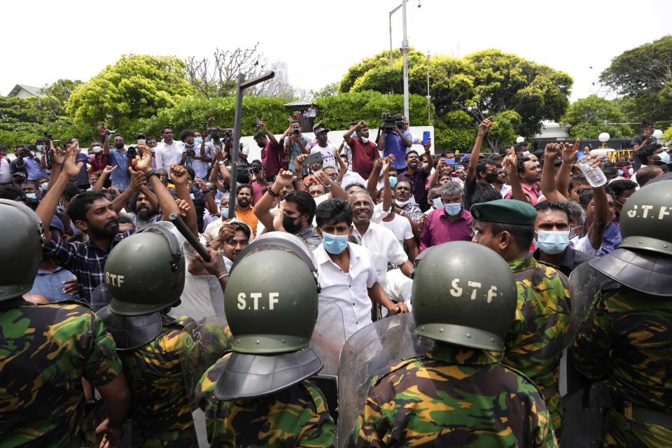 Sri Lankan government supporters cheer after vandalizing the site of anti-government protest outside prime minister's residence in Colombo, Sri Lanka, Monday, May 9, 2022. Authorities deployed armed troops in the capital Colombo on Monday hours after government supporters attacked protesters who have been camped outside the offices of the country's president and prime minster, as trade unions began a “Week of Protests” demanding the government change and its president to step down over the country’s worst economic crisis in memory. (AP Photo/Eranga Jayawardena)
