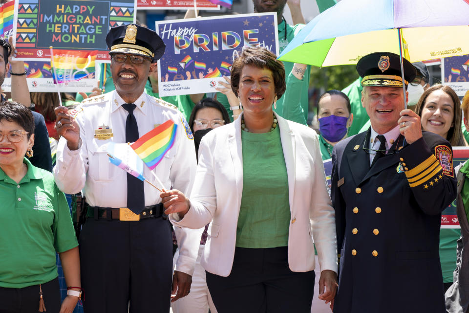 District of Columbia Mayor Muriel Bowser, center, attends a news conference ahead of DC Pride events, with Metropolitan Police Chief Robert Contee III, left, and Fire and EMS Chief John Donnelly, Sr., right, Friday, June 10, 2022, in Washington. Bowser is seeking a third term in office. (AP Photo/Jacquelyn Martin)