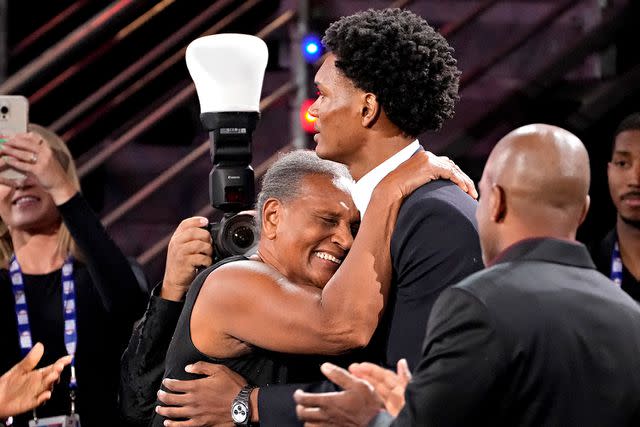 <p>John Minchillo/AP</p> Ausar Thompson, right, hugs family and friends after being selected fifth overall by the Detroit Pistons during the NBA basketball draft, Thursday, June 22, 2023, in New York