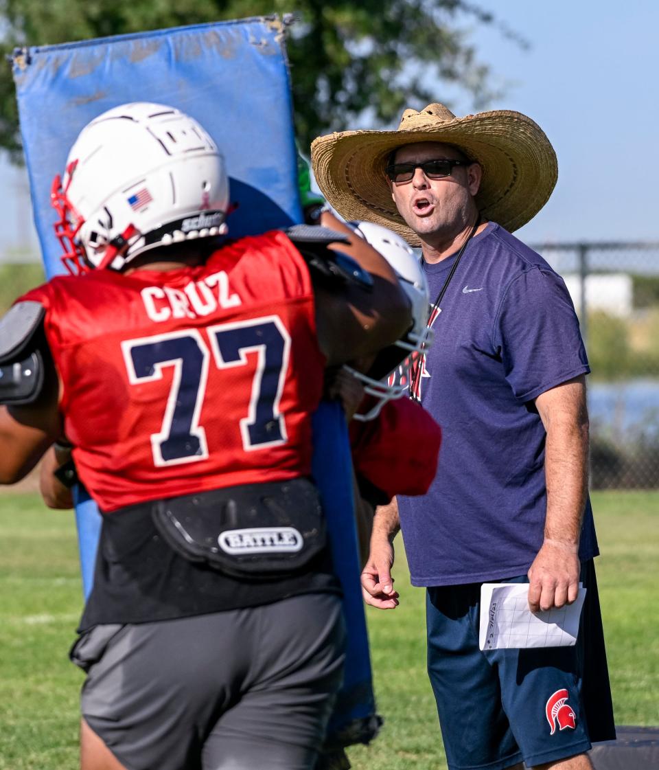 Head Football Coach Jeromy Blackwell works with his team on Wednesday, July 26, 2023 at Strathmore High School. Blackwell has returned to the job he loves and is still recovering after a life-threatening health scare that put him in the hospital for two weeks in June.