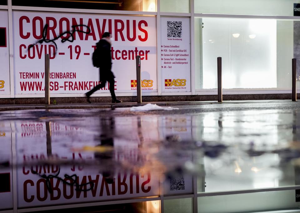 FILE-A woman walks past an abandoned coronavirus test center in Frankfurt, Tuesday, Nov. 2, 2021. Numbers of coronavirus infections are rising again in Germany. Germany's disease control agency has reported the highest number of new infections with the coronavirus since the outbreak of the pandemic. (AP Photo/Michael Probst, File)