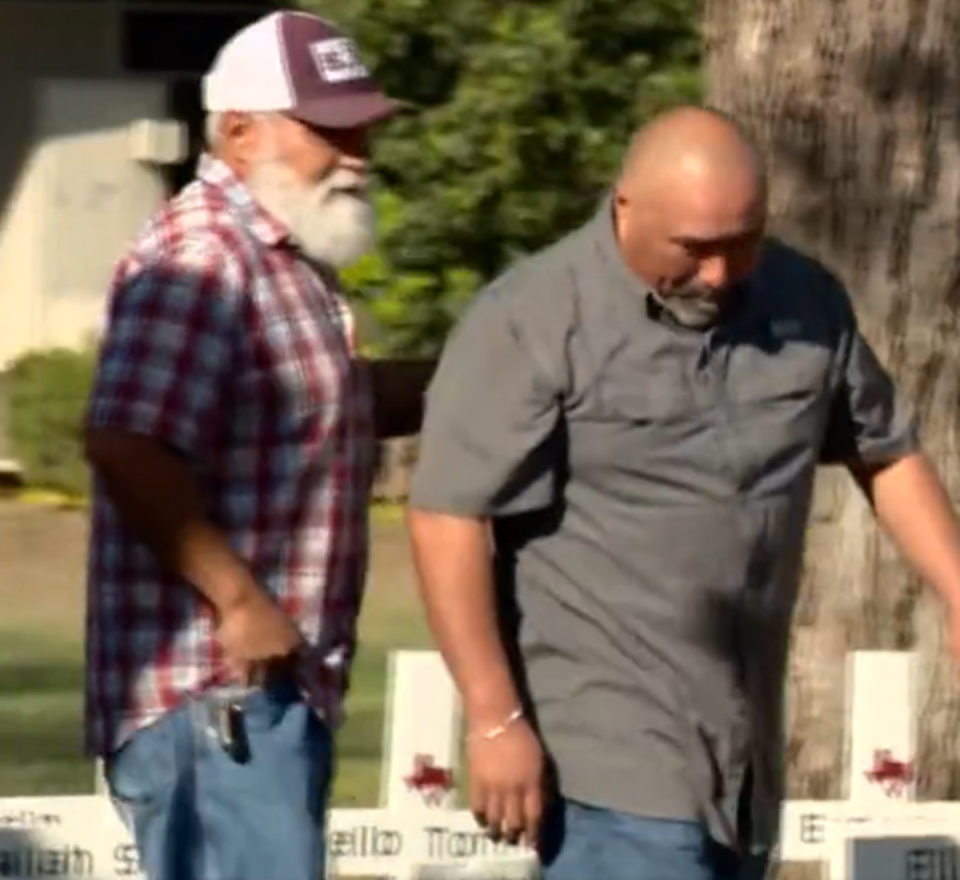 Mr Garcia (R) placing flowers at a memorial to his wife hours before dying of a heart attack (Screengrab)