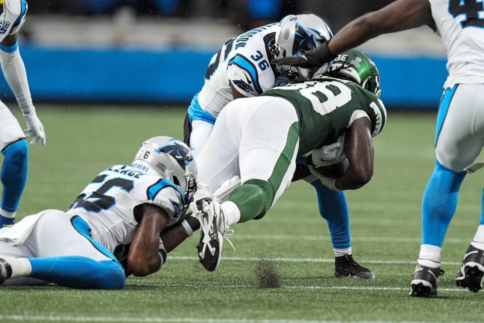 Aug 17, 2024; Charlotte, North Carolina, USA; Carolina Panthers safety Demani Richardson (36) hits New York Jets running back Deon Jackson (38)during the first quarter at Bank of America Stadium. Mandatory Credit: Jim Dedmon-USA TODAY Sports