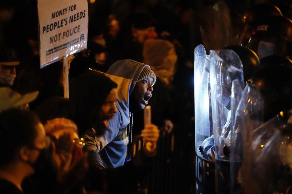 Protesters confront police during a march Tuesday Oct. 27, 2020 in Philadelphia. Hundreds of demonstrators marched in West Philadelphia over the death of Walter Wallace, a Black man who was killed by police in Philadelphia on Monday. Police shot and killed the 27-year-old on a Philadelphia street after yelling at him to drop his knife. (AP Photo/Matt Slocum)