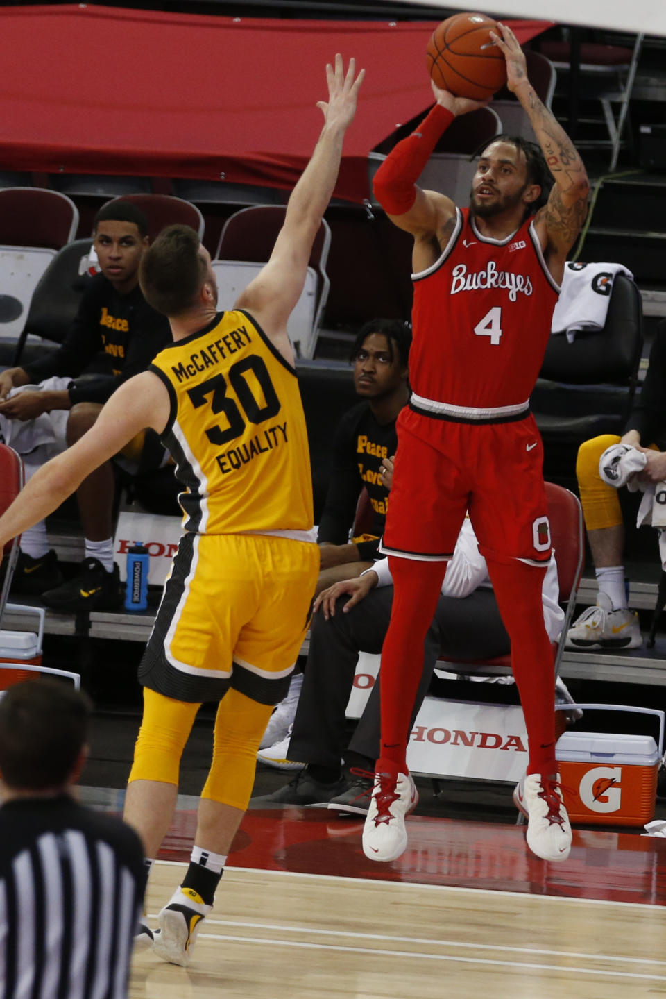 Ohio State's Duane Washington, right, shoots over Iowa's Connor McCaffery during the first half of an NCAA college basketball game Sunday, Feb. 28, 2021, in Columbus, Ohio. (AP Photo/Jay LaPrete)