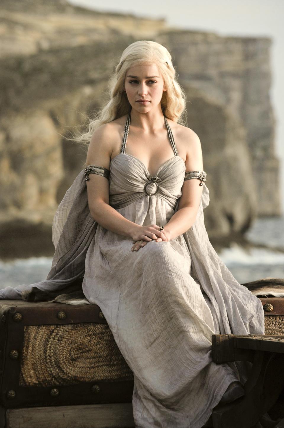 Much like her other fellow leads, Daenerys Targaryen was a child when we first met her, and her early styling reflected her status as a child bride specifically. Her silvery hair is youthful and loose, she's dressed in gauzy, flowing garments that befit the warmer eastern climes, and <a href="https://www.allure.com/story/emilia-clarke-cover-interview-2019-game-of-thrones-escapism?mbid=synd_yahoo_rss" rel="nofollow noopener" target="_blank" data-ylk="slk:Emilia Clarke's makeup;elm:context_link;itc:0;sec:content-canvas" class="link "><strong>Emilia Clarke</strong>'s makeup</a> is light and fresh and paired with glowing skin.