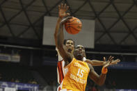 Tennessee guard Jahmai Mashack (15) gets fouled by Syracuse forward Chris Bell during the second half of an NCAA college basketball game, Monday, Nov. 20, 2023, in Honolulu. (AP Photo/Marco Garcia)