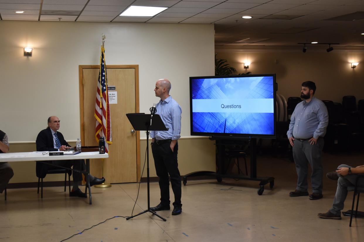 Mission Critical Partners' Tim Hennemann and Madison County 911 call center director Caleb Dispenza collaborated on a needs assessment of the county's public safety radio network. Here, Hennemann and Dispenza report their findings to the county commissioners Nov. 9.