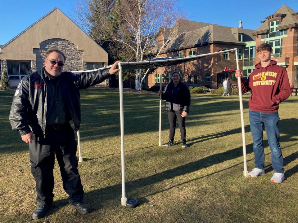 Gannon University educator and astronomer David Horne, on left, stands with Gannon engineering students Claire Rogillio and John Brady, who helped design and develop an eclipse "viewing window" that will allow groups of people to watch the eclipse without safety glasses.