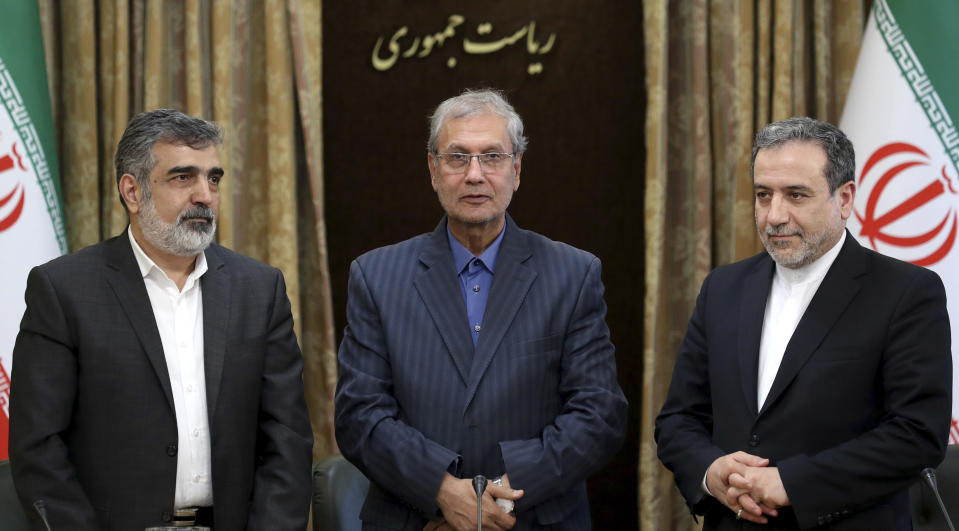 From left to right, spokesman for Iran's atomic agency Behrouz Kamalvandi, Iran's government spokesman Ali Rabiei and Iranian Deputy Foreign Minister Abbas Araghchi, attend a press briefing in Tehran, Iran, Sunday, July 7, 2019. The deputy foreign minister says that his nation considers the 2015 nuclear deal with world powers to be a "valid document" and seeks its continuation. (AP Photo/Ebrahim Noroozi)