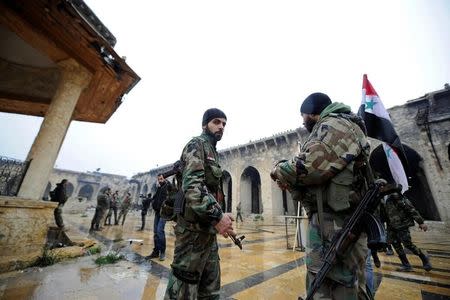 Forces loyal to Syria's President Bashar al-Assad stand inside the Umayyad mosque, in the government-controlled area of Aleppo, during a media tour, Syria December 13, 2016. REUTERS/Omar Sanadiki