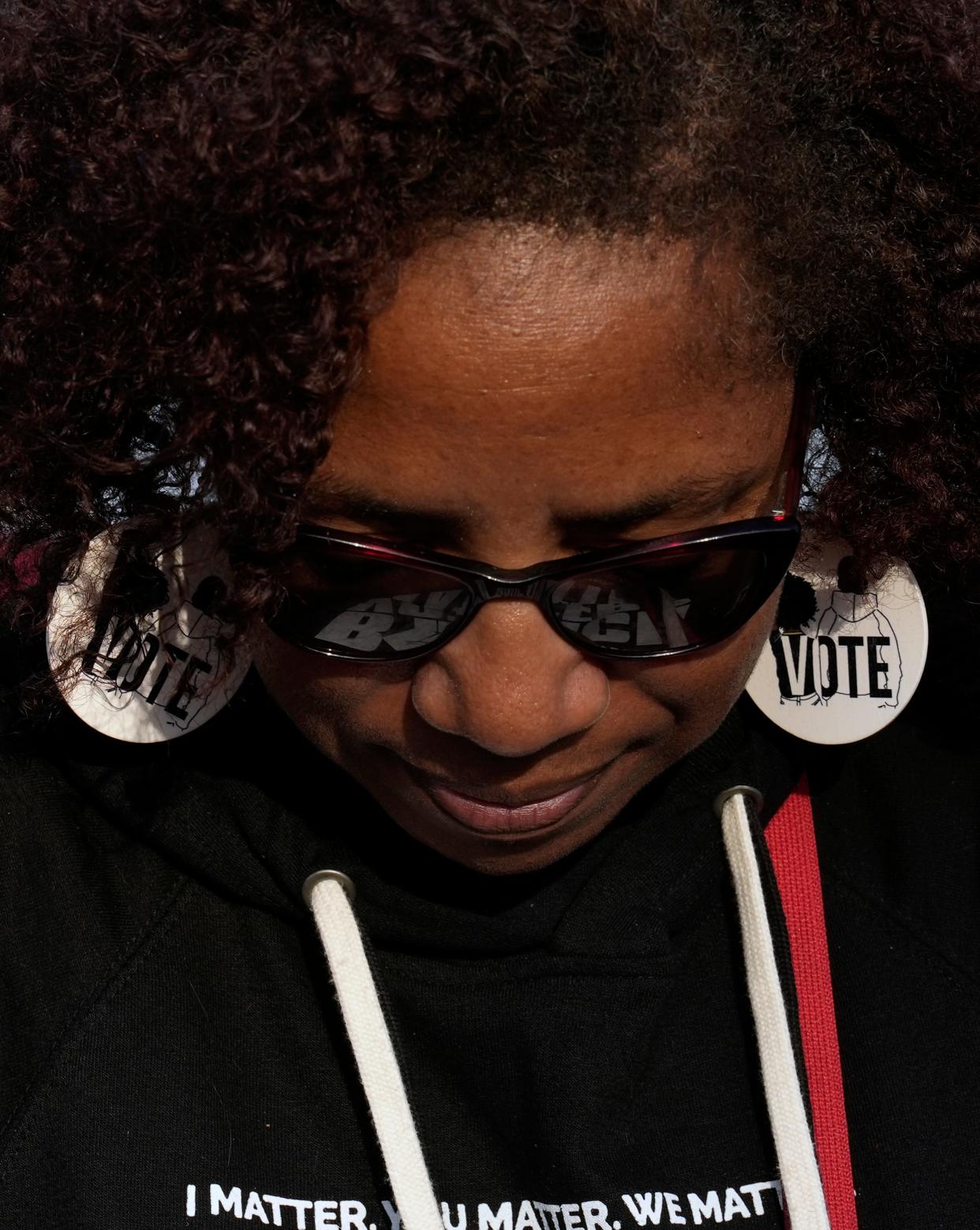 Nov. 1, 2022; Columbus, Ohio, USA; Wanda Mosley of Atlanta wears "Vote" earrings while representing the Black Voters Matter "We Won't Black Down"  campaign at the Town and Country shopping center on the East Side of Columbus Tuesday evening. The nonprofit group made Columbus one twelve stops on a fall bus tour to engage with Black voters and raise awareness on issues impacting Black communities. Mandatory Credit: Barbara J. Perenic/Columbus Dispatch