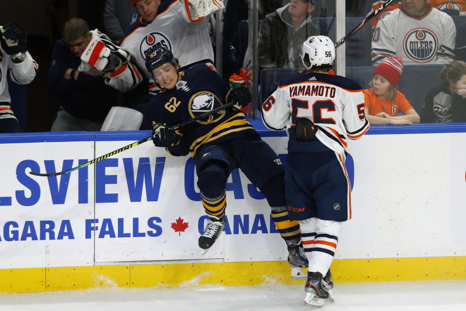 Buffalo Sabres defenseman Brandon Monyour (62) is checked by Edmonton Oilers forward Kailer Yamamoto (56) during the first period of an NHL hockey game Thursday, Jan. 2, 2020, in Buffalo, N.Y. (AP Photo/Jeffrey T. Barnes)