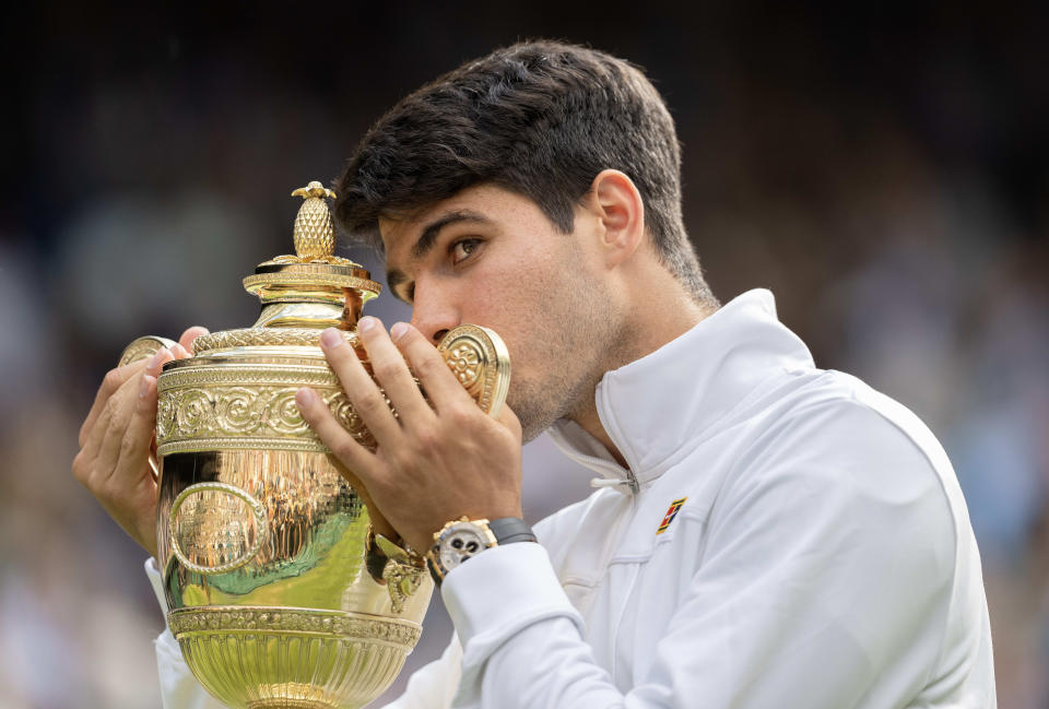 Carlos Alcaraz of Spain kisses the Wimbledon trophy after winning the men's singles match against Novak Djokovic of Serbia (Reuters via Beat Media Group subscription)