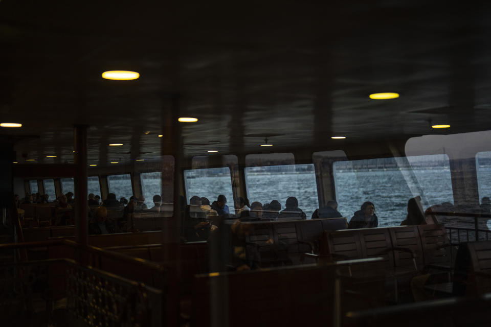 Commuters take a ride crossing the Bosphorus in a ferry boat in Istanbul, Turkey, Wednesday, March 20, 2024. (AP Photo/Francisco Seco)