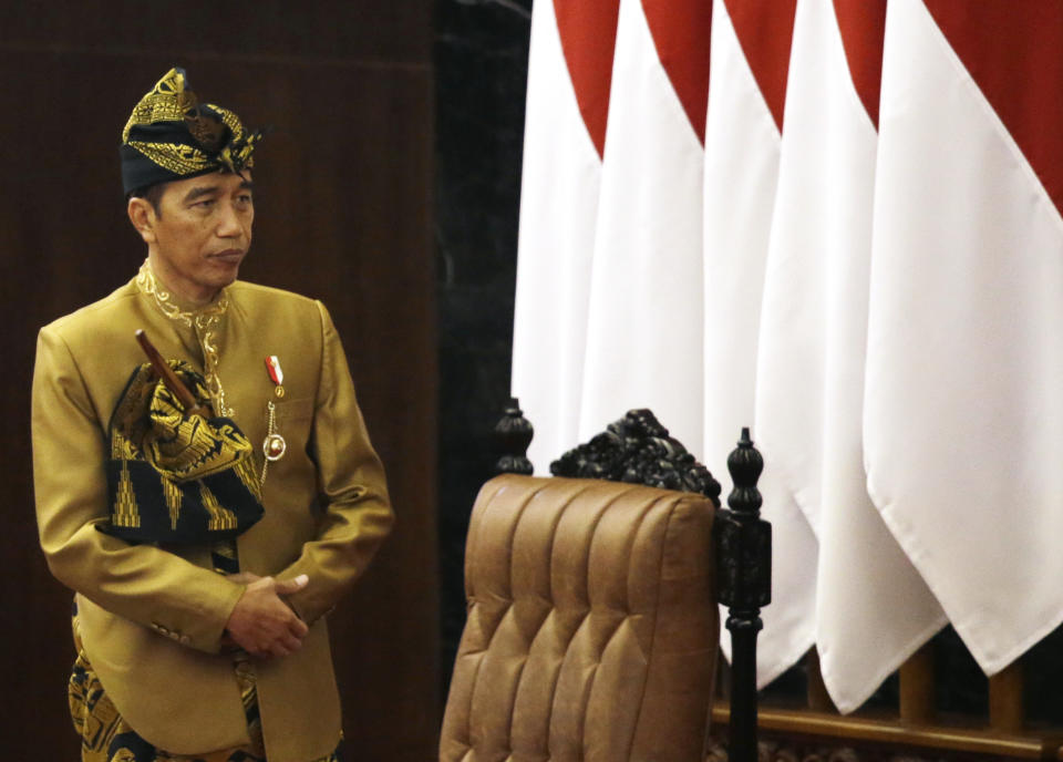 Indonesia's President Joko Widodo in Nusa Tenggara Barat traditional dress, stands after delivers his state of the nation address ahead of the country's Independence Day at the parliament building in Jakarta, Indonesia, Friday, Aug. 16, 2019. Widodo has appealed support to move the country's capital outside of its most populous island, Java, in an annual national address.(AP Photo/Achmad Ibrahim)