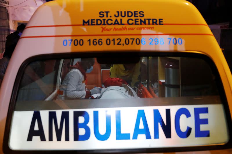 Medics examine a pregnant woman in an ambulance during the coronavirus night curfew in Nairobi